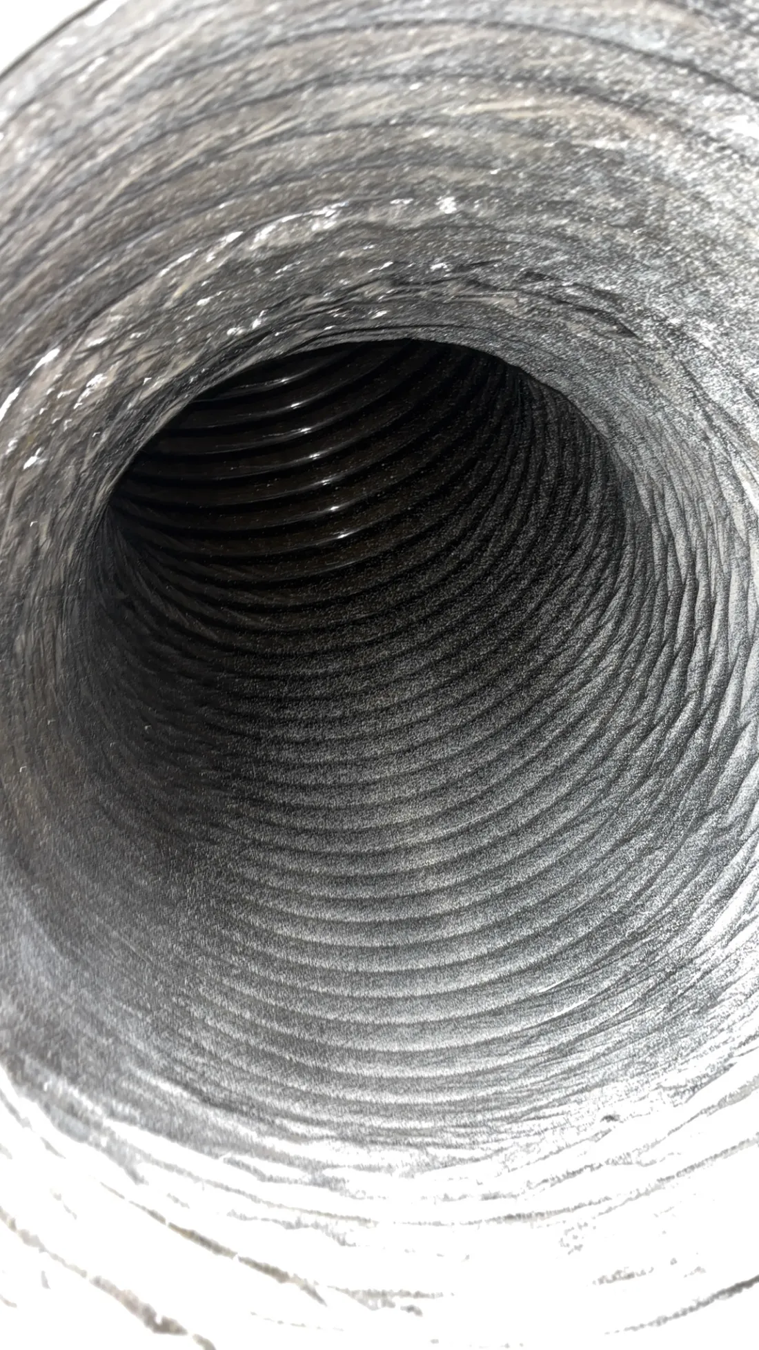 Flex duct interior after agitation and cleaning, walls clear through the first bend