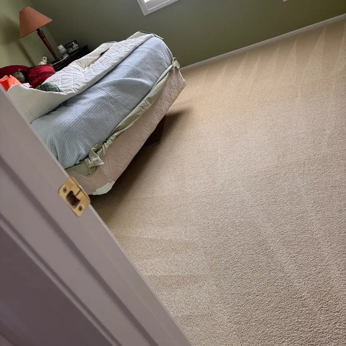 Cleaned bedroom carpet showing fresh extraction lines across the floor