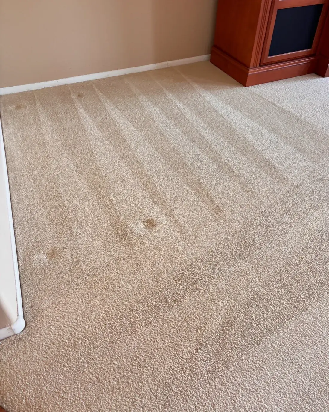 Beige carpet after cleaning with a few remaining spots visible