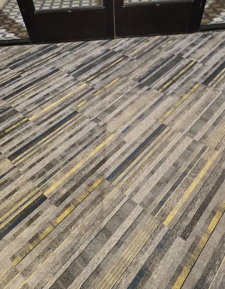 Cleaned patterned carpet tile at a building entrance