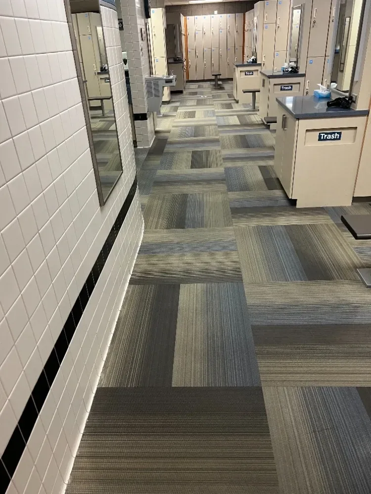 Carpet tile running through a fitness facility locker room