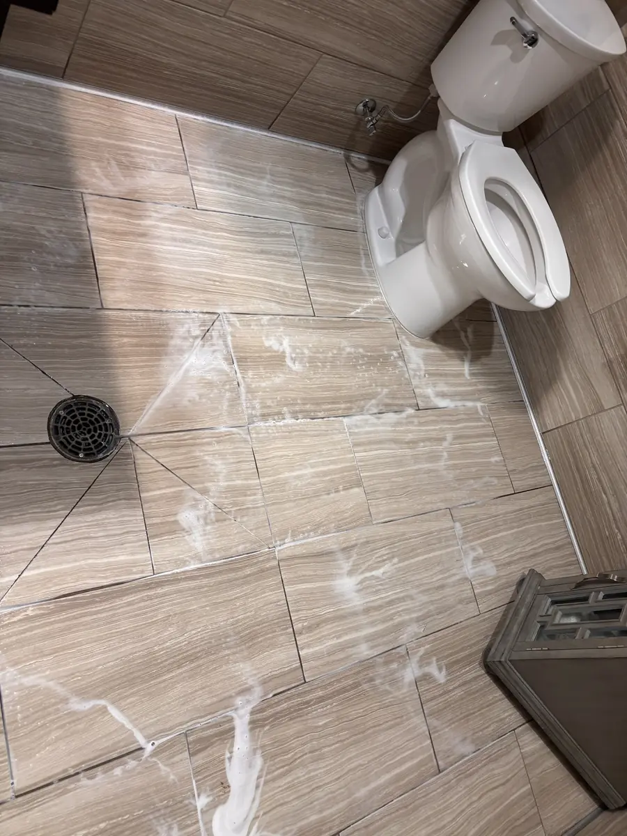 Commercial restroom tile being cleaned