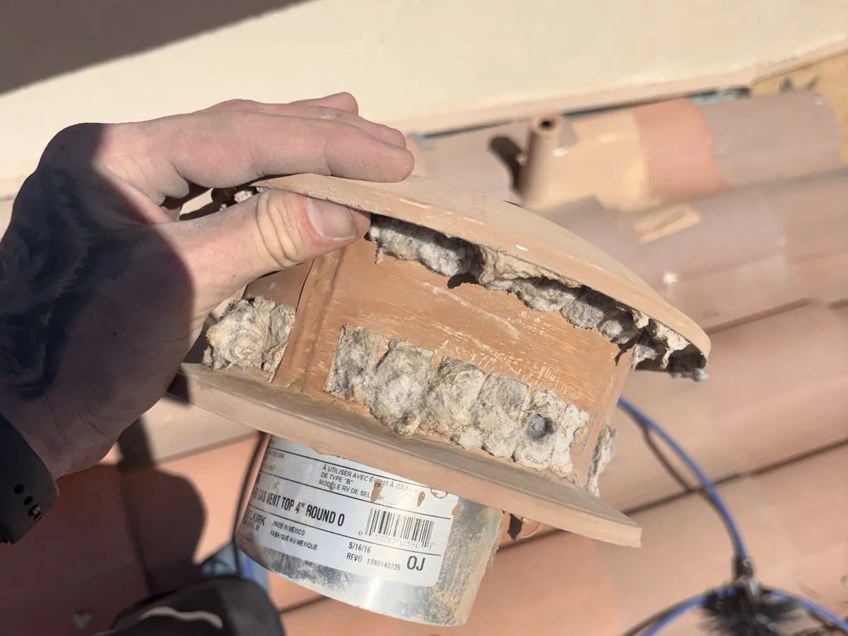 Roof vent cap packed with lint before cleaning