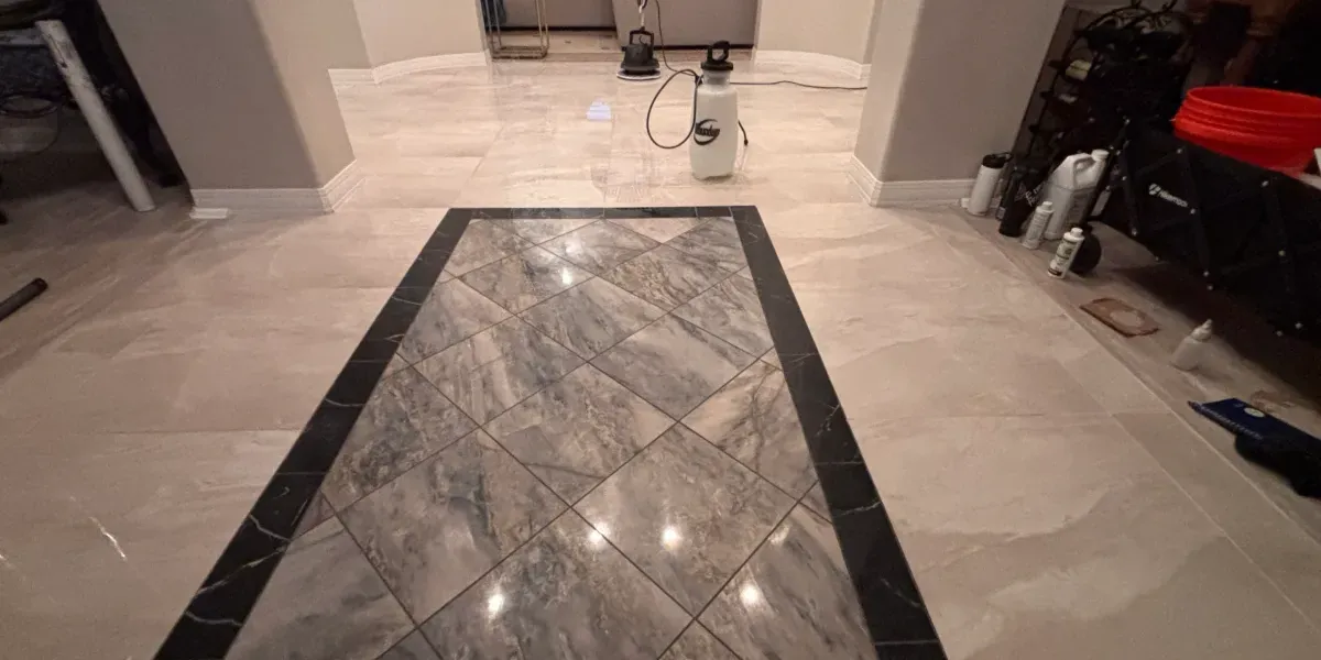Marble entry floor with a black stone border inlay after cleaning