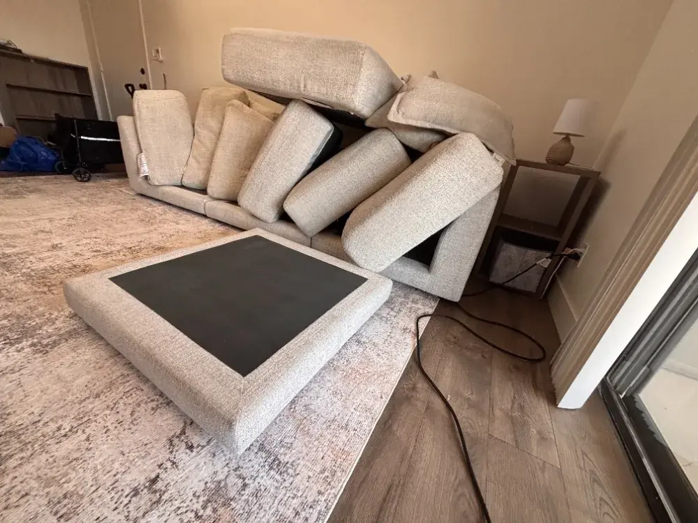 Sectional stripped down with every cushion pulled for individual cleaning