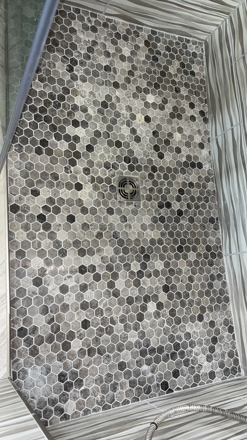 Hexagon marble mosaic shower pan after grout color sealing, every line one uniform color