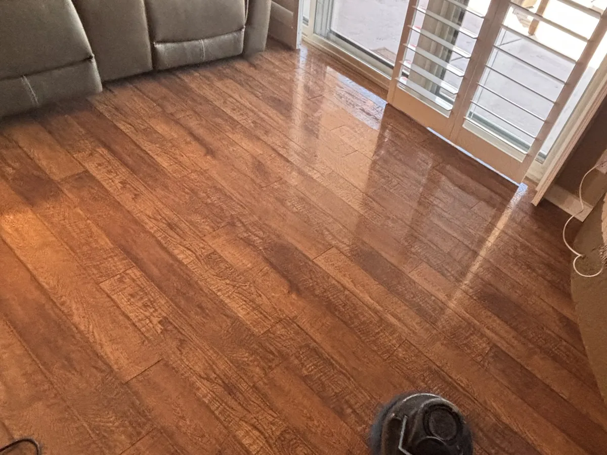 Wood floor being machine cleaned